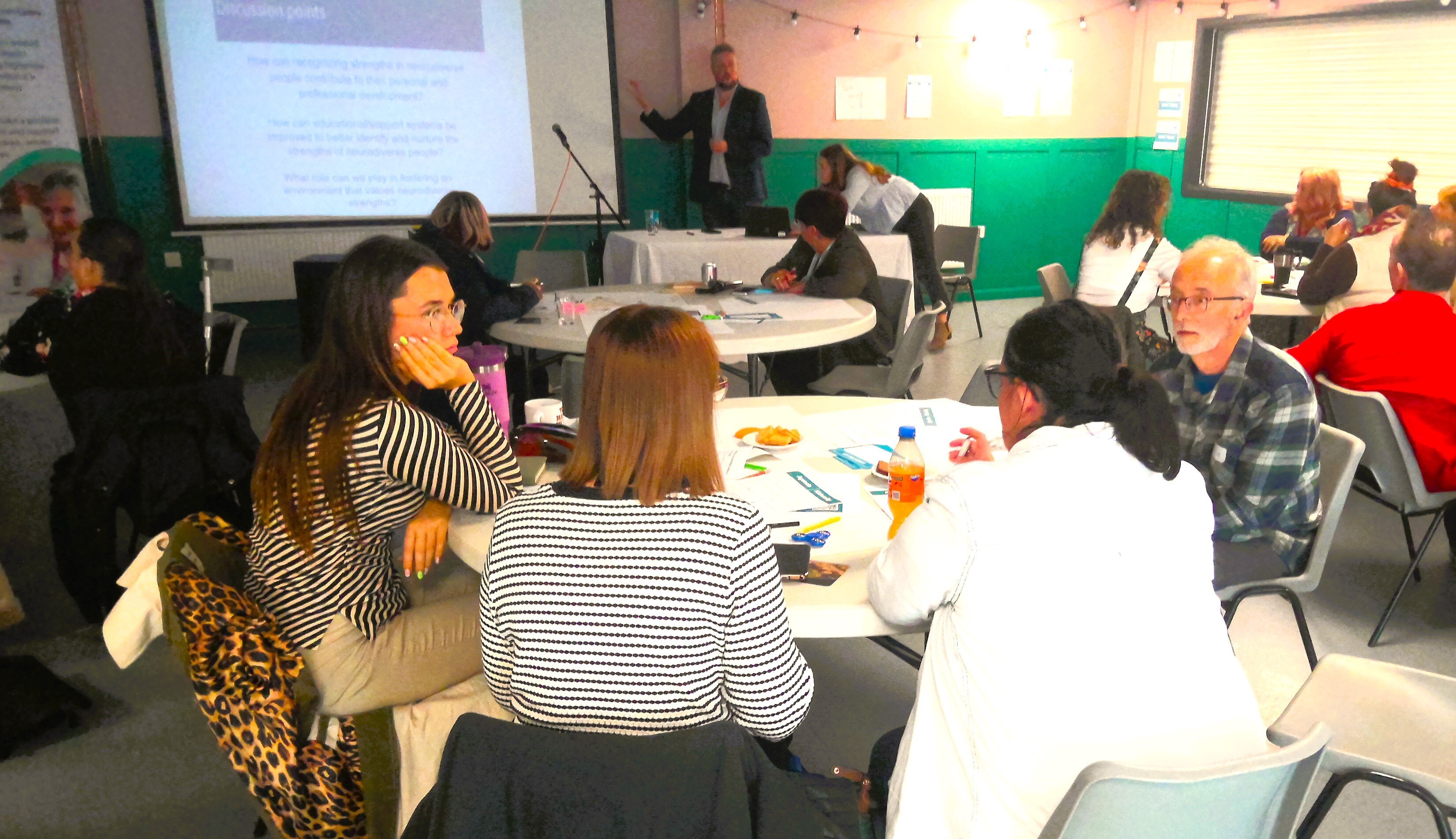 Speaker presenting in a workshop setting