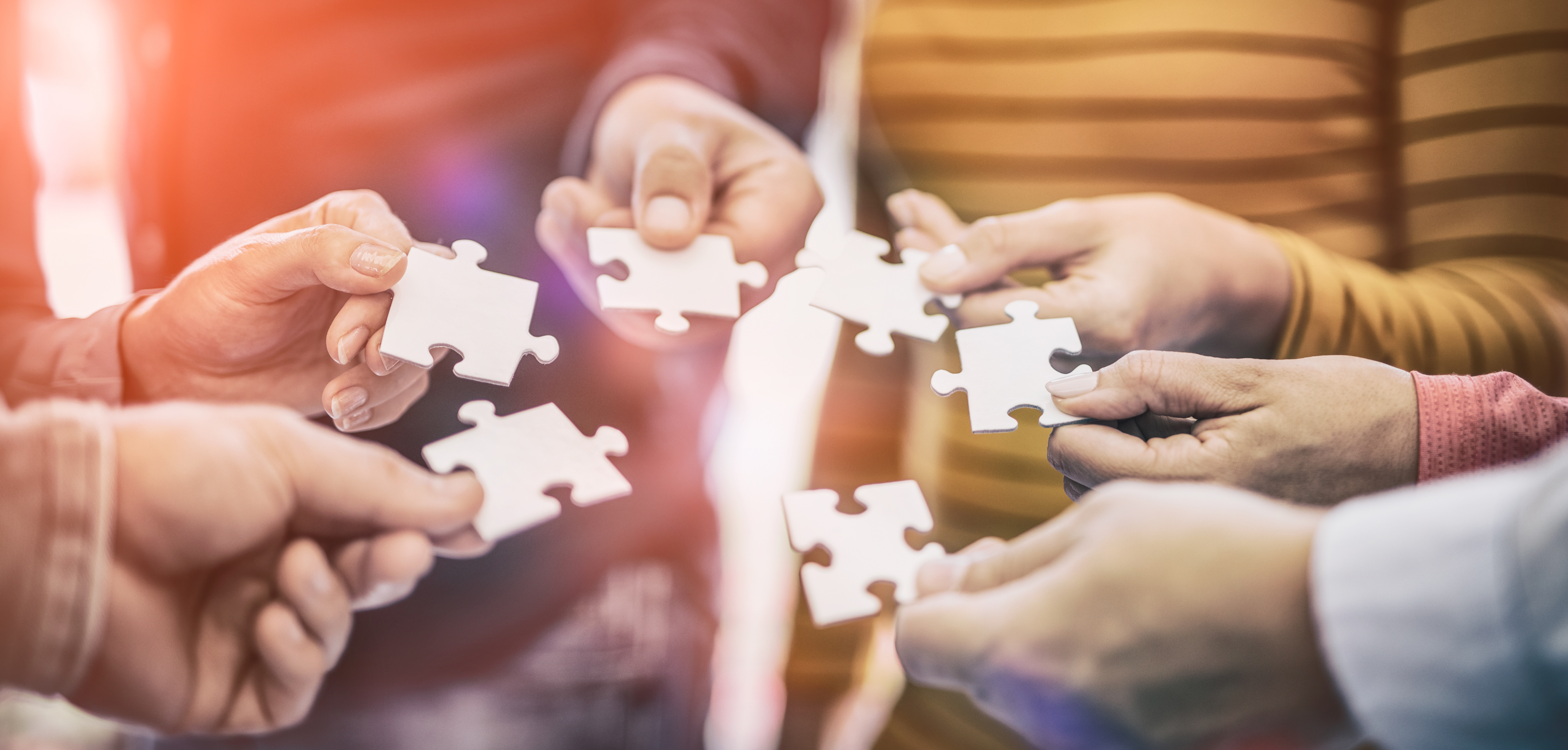 Hands holding jigsaw pieces