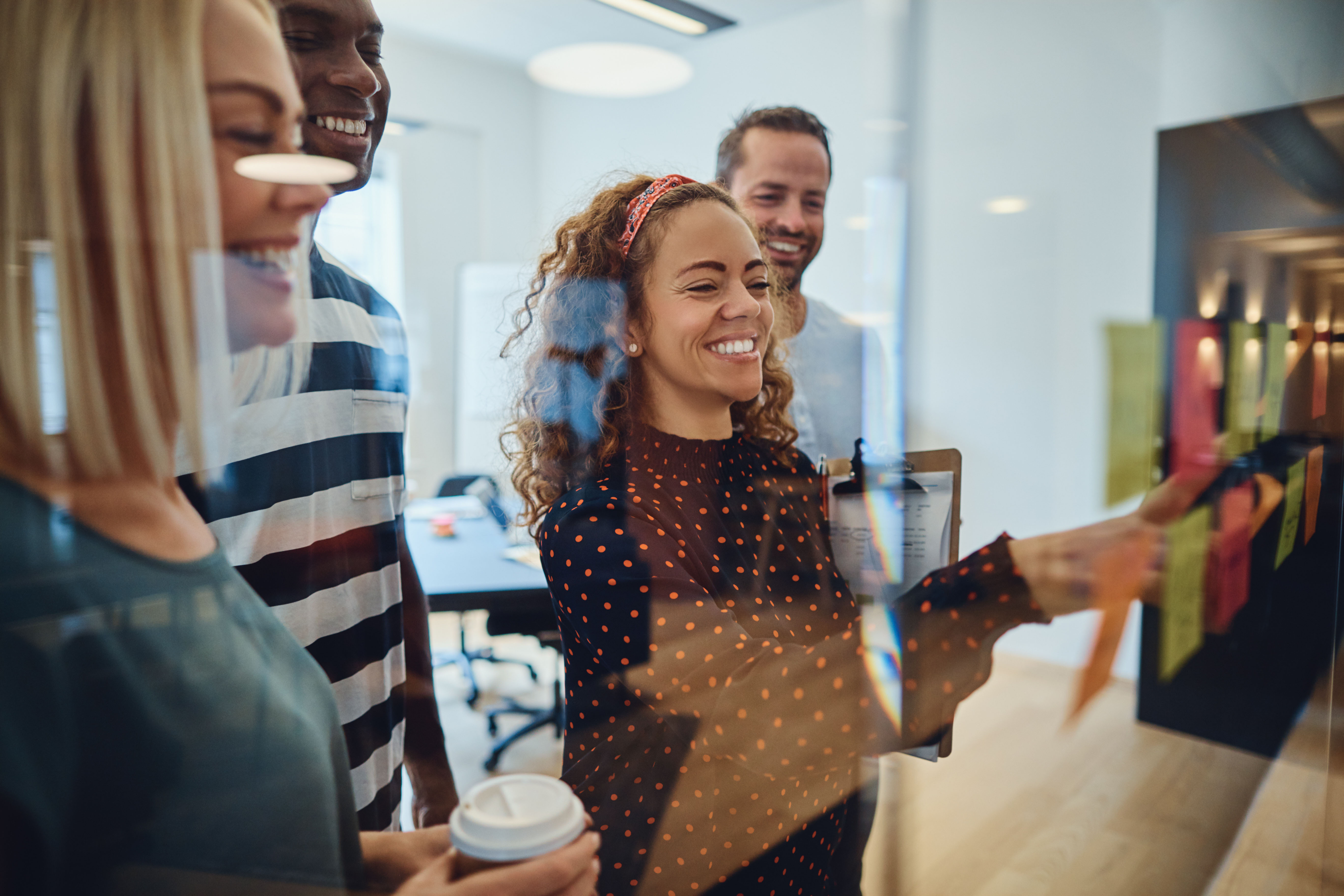 Group of people using post-it notes in a meeting.